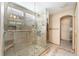 Spa-like bathroom with a large, tiled shower, glass door, and built-in niches at 11335 W 54Th Ln, Arvada, CO 80002