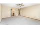 Large bedroom with neutral carpet, ceiling fan, and multiple entryways at 11335 W 54Th Ln, Arvada, CO 80002