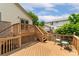 An outdoor deck with wood railings and stairs and wrought iron table and chairs at 11335 W 54Th Ln, Arvada, CO 80002