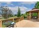 A spacious wooden deck featuring a gazebo, wrought iron table and chairs, and a scenic view at 11335 W 54Th Ln, Arvada, CO 80002