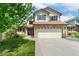Charming two-story home with a manicured lawn, brick accents, and a spacious two car garage, located at 11335 at 11335 W 54Th Ln, Arvada, CO 80002