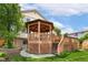 A backyard gazebo that sits on a wooden deck with stairs and lattice base at 11335 W 54Th Ln, Arvada, CO 80002