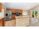 Bright kitchen with stainless steel appliances, granite countertops, a breakfast bar, and access to an outdoor patio at 11335 W 54Th Ln, Arvada, CO 80002