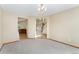 Spacious living room featuring an open floor plan, archways, and neutral carpet at 11335 W 54Th Ln, Arvada, CO 80002