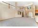 Spacious living room with high ceilings, large windows, a staircase, and neutral carpet at 11335 W 54Th Ln, Arvada, CO 80002