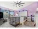 Bright bedroom with purple walls, plush carpet floors and a large window for natural light at 16160 E 119Th Ave, Commerce City, CO 80022