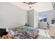 Bedroom featuring a ceiling fan, a window with a view, and neutral paint at 16160 E 119Th Ave, Commerce City, CO 80022