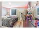 Cozy bedroom with light gray walls, accent lighting, and light wood floors at 16160 E 119Th Ave, Commerce City, CO 80022