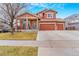 Inviting two-story home with a spacious three-car garage and a charming front porch at 16160 E 119Th Ave, Commerce City, CO 80022