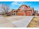 Charming two-story home with a three-car garage and well-maintained landscaping at 16160 E 119Th Ave, Commerce City, CO 80022