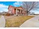 Charming two-story home with red siding, covered porch, and a spacious three-car garage at 16160 E 119Th Ave, Commerce City, CO 80022