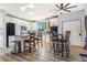 Bright kitchen with white cabinets, stainless steel appliances, an island with seating, and vinyl plank flooring at 16160 E 119Th Ave, Commerce City, CO 80022