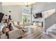 Bright living room featuring a modern sectional sofa, vaulted ceilings, and a large bay window for lots of natural light at 16160 E 119Th Ave, Commerce City, CO 80022