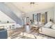 Inviting living room with hardwood floors, neutral paint, staircase, and large windows that provide lots of natural light at 16160 E 119Th Ave, Commerce City, CO 80022