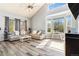 Spacious living room featuring two modern sofas, vaulted ceilings, and large windows for lots of natural light at 16160 E 119Th Ave, Commerce City, CO 80022