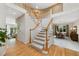 Elegant two-story entryway with hardwood floors and curved staircase at 39 Golden Eagle Ln, Littleton, CO 80127