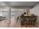 Modern finished basement bar with brick facade, seating, and view of the backyard through a glass door at 1769 W 113Th Ave, Denver, CO 80234