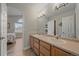 Bright bathroom with double sink vanity, open view to the bedroom at 1769 W 113Th Ave, Denver, CO 80234