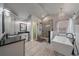 Bright bathroom features freestanding tub, glass shower, chandelier, and granite countertops at 1769 W 113Th Ave, Denver, CO 80234