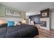 Relaxing bedroom with dark textured accent wall, modern fireplace, and luxury chaise lounge at 1769 W 113Th Ave, Denver, CO 80234