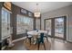 Sun-drenched breakfast nook features a round table, designer chairs and access to the outdoor deck at 1769 W 113Th Ave, Denver, CO 80234