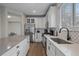 Bright kitchen with white cabinets, stainless steel appliances, quartz countertops and hardwood flooring at 1769 W 113Th Ave, Denver, CO 80234