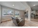 Finished basement rec room with a sliding glass door, wood floors and a sleek, modern bar area at 1769 W 113Th Ave, Denver, CO 80234