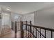 Elegant staircase with hardwood steps, iron railings, and a large arched window for natural light at 1769 W 113Th Ave, Denver, CO 80234