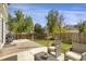 Inviting backyard featuring a patio area, seating, a grill, and a well-maintained lawn with a wooden fence at 2432 S Genoa Way, Aurora, CO 80013