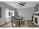 Cozy dining room with fireplace, modern chandelier, and large windows at 2432 S Genoa Way, Aurora, CO 80013