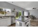 Modern kitchen with island, granite countertops, stainless steel appliances, and access to backyard at 2432 S Genoa Way, Aurora, CO 80013