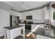 Bright kitchen featuring stainless steel appliances, granite counters, and white cabinetry at 2432 S Genoa Way, Aurora, CO 80013