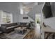 Bright living room with vaulted ceilings, a cozy gray sectional, and stylish decor accents at 2432 S Genoa Way, Aurora, CO 80013