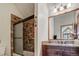 Bathroom featuring stone shower and a wooden vanity with double sinks at 47 Forest Cir, Breckenridge, CO 80424