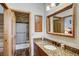 Classic bathroom with granite countertop vanity, framed mirror, and tile/stone accented shower at 47 Forest Cir, Breckenridge, CO 80424