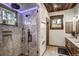 Stunning bathroom featuring river rock shower with glass door and rustic wood accents at 47 Forest Cir, Breckenridge, CO 80424