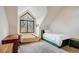 Bedroom features a pitched ceiling, large window, and neutral carpet at 47 Forest Cir, Breckenridge, CO 80424
