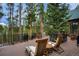 Inviting outdoor deck with comfortable seating and scenic views of the surrounding evergreen trees at 47 Forest Cir, Breckenridge, CO 80424