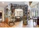 Open-concept dining area highlighted by a stone archway, hardwood floors, and nature views from ample windows at 47 Forest Cir, Breckenridge, CO 80424
