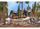 Charming outdoor space with a stone fire pit and woodpile, set against the backdrop of a beautiful home at 47 Forest Cir, Breckenridge, CO 80424
