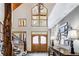 Grand foyer with stone floors, a wooden staircase, and large windows showcasing the surrounding landscape at 47 Forest Cir, Breckenridge, CO 80424