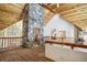 Unique home interior featuring stone chimney, exposed wood beams, and rustic-style railings at 47 Forest Cir, Breckenridge, CO 80424