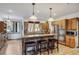 Well-appointed kitchen featuring wood cabinets, granite counters, stainless appliances, and a breakfast bar with leather stools at 47 Forest Cir, Breckenridge, CO 80424