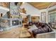 Open-concept living room featuring a stone fireplace and an adjoining kitchen area at 47 Forest Cir, Breckenridge, CO 80424