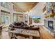 Spacious living room with large windows, vaulted wood ceilings, a stone fireplace, and comfortable seating for relaxing at 47 Forest Cir, Breckenridge, CO 80424