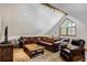 Comfortable living room with vaulted ceiling, natural wood beams, large windows and cozy seating at 47 Forest Cir, Breckenridge, CO 80424