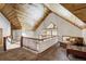 Loft sitting area with a pitched wood ceiling, carpet, and large windows providing natural light at 47 Forest Cir, Breckenridge, CO 80424