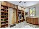 Functional mudroom with custom wooden cabinets, storage cubbies, sink, and durable tile flooring at 47 Forest Cir, Breckenridge, CO 80424