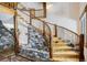 Unique staircase featuring stonework accents and rustic wooden railings adds natural charm to the home's interior design at 47 Forest Cir, Breckenridge, CO 80424