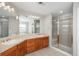 Bright bathroom with double vanity, shower, tub, and large mirrors at 47032 Frasier Fir Cir, Parker, CO 80138